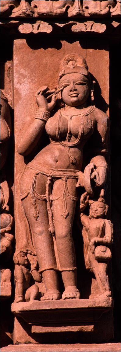 Woman applying eyeshadow, Parsvanath Temple, Khajuraho, India